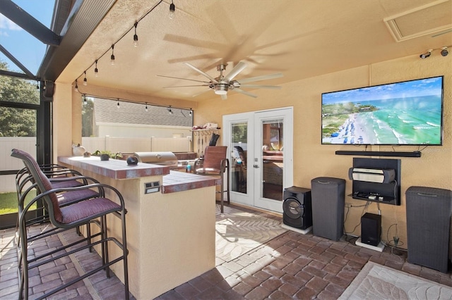 view of patio featuring ceiling fan and an outdoor bar