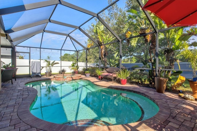 view of pool with an in ground hot tub, a lanai, and a patio area