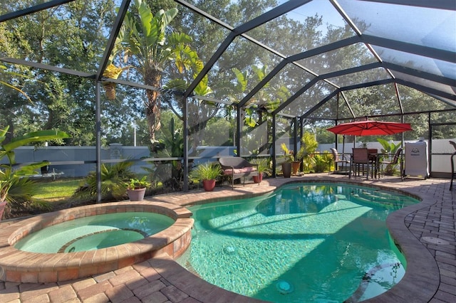 view of pool with a patio and glass enclosure