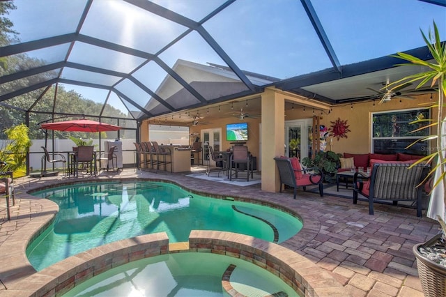 view of swimming pool featuring outdoor lounge area, ceiling fan, french doors, a bar, and a patio