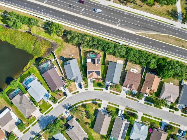 birds eye view of property with a water view