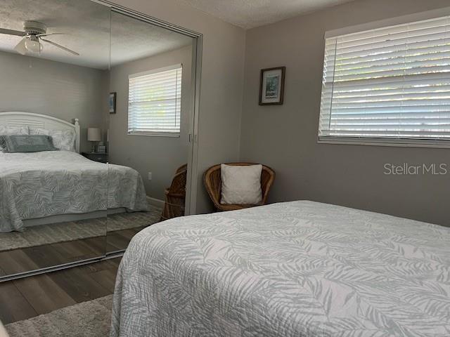 bedroom with ceiling fan and wood-type flooring