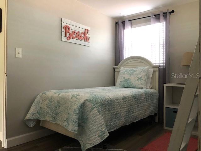 bedroom with dark wood-type flooring