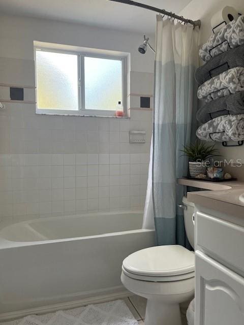 full bathroom featuring toilet, vanity, and shower / bath combination with curtain