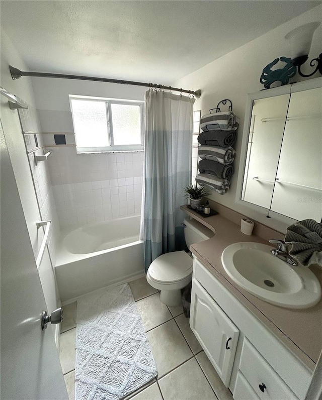 full bathroom featuring toilet, vanity, tile patterned flooring, and shower / bath combo with shower curtain