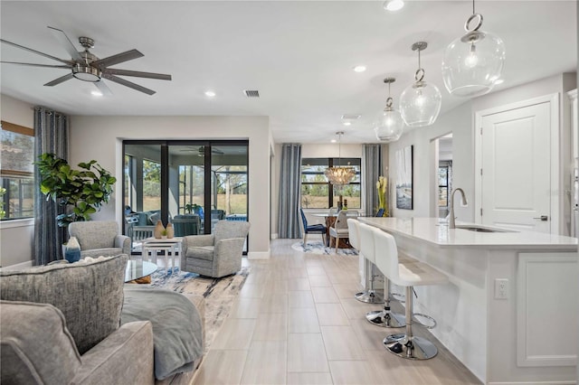 living room with ceiling fan and sink