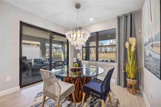 dining area with a healthy amount of sunlight and a notable chandelier