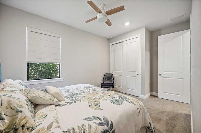 carpeted bedroom featuring a closet and ceiling fan