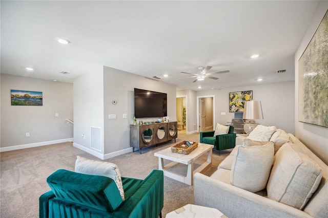 carpeted living room with ceiling fan