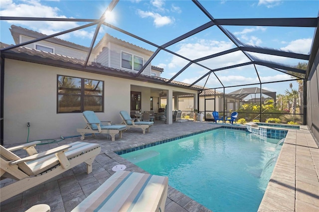 view of swimming pool with a lanai, an in ground hot tub, and a patio