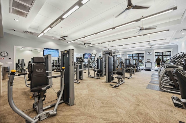 exercise room featuring light colored carpet and ceiling fan