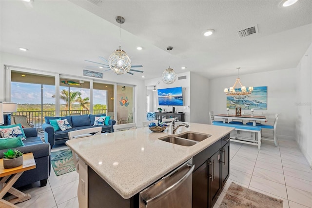 kitchen with sink, dishwasher, a kitchen island with sink, and decorative light fixtures