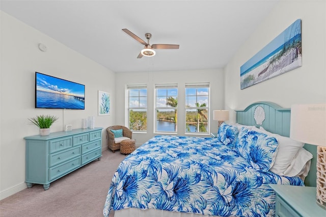 bedroom with ceiling fan and light carpet