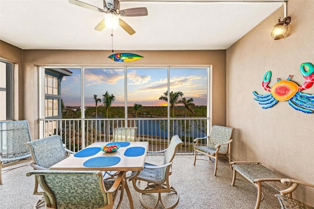 sunroom featuring ceiling fan