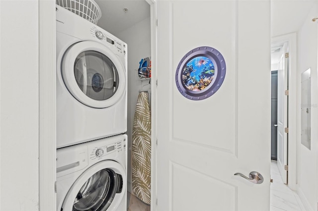 clothes washing area featuring stacked washer and dryer