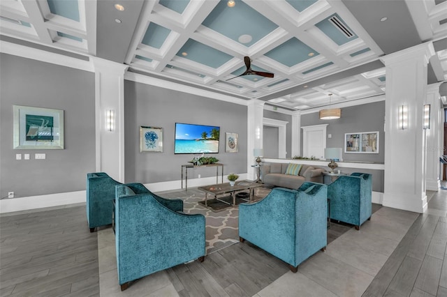 living room with ornate columns, coffered ceiling, and hardwood / wood-style floors