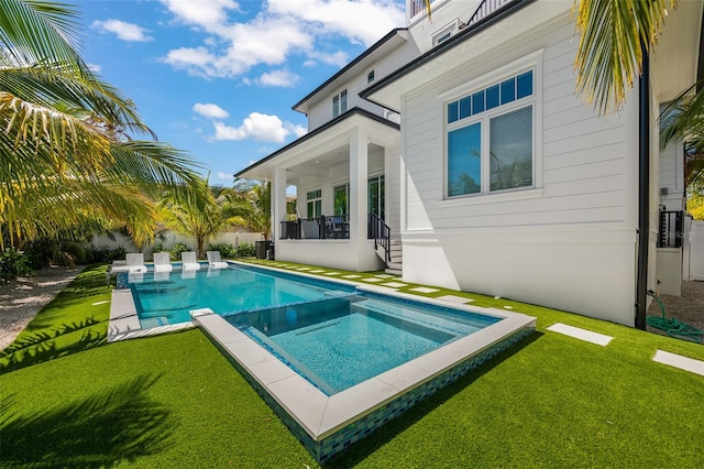 view of swimming pool with a lawn