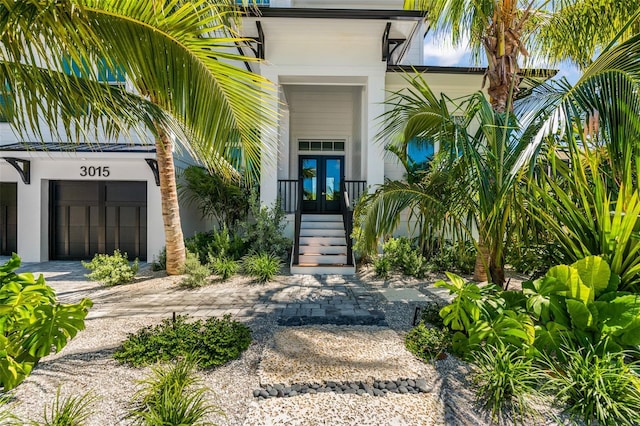 doorway to property featuring a garage and french doors