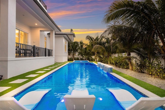 view of pool at dusk