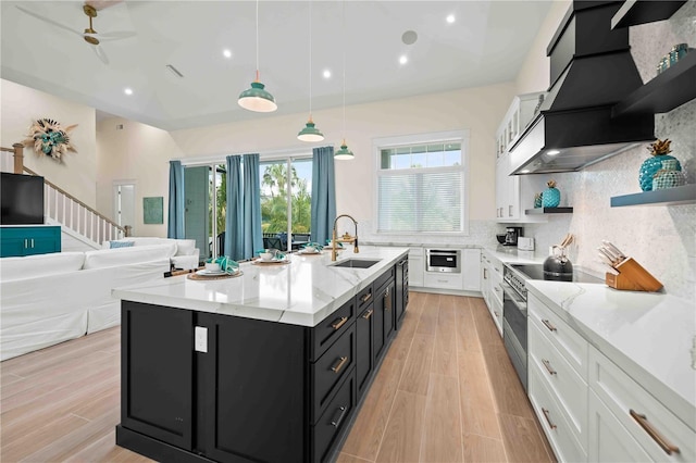 kitchen with stainless steel electric range oven, white cabinetry, sink, and pendant lighting