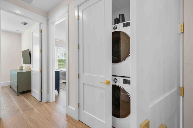 laundry area featuring stacked washer / dryer