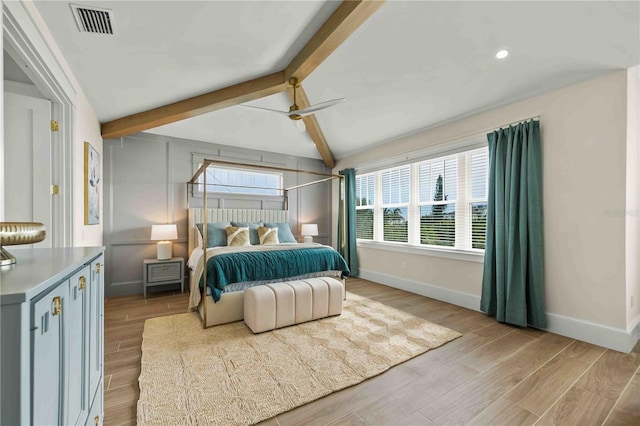 bedroom featuring vaulted ceiling with beams, ceiling fan, and light hardwood / wood-style floors