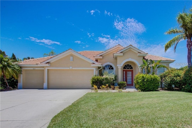 mediterranean / spanish-style house with a front yard and a garage