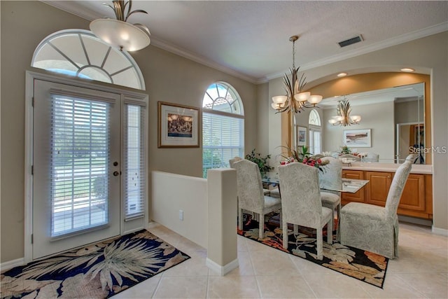 dining space with plenty of natural light, light tile patterned floors, crown molding, and an inviting chandelier