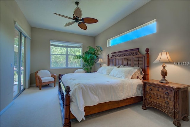 bedroom with access to outside, multiple windows, ceiling fan, and light colored carpet