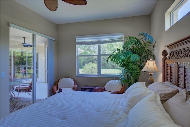 bedroom with multiple windows, access to exterior, and ceiling fan