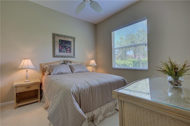 bedroom featuring ceiling fan and light carpet