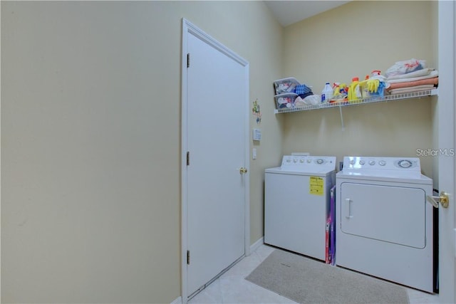 laundry area featuring washer and dryer and light tile patterned floors