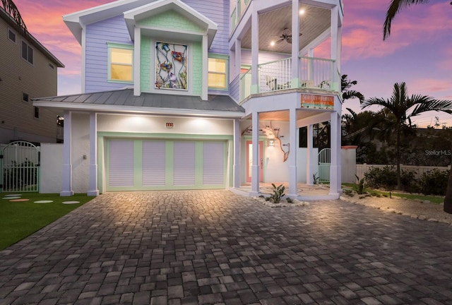 view of front of home featuring a garage and a balcony