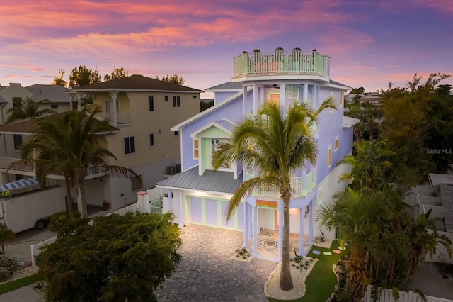 view of front facade with a balcony and a garage