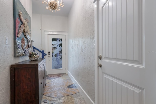 doorway featuring a notable chandelier