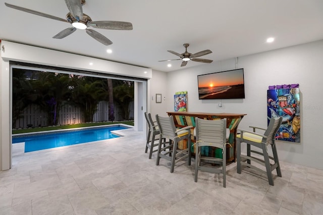 view of swimming pool featuring ceiling fan