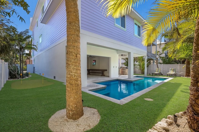 view of swimming pool with a patio area and a lawn