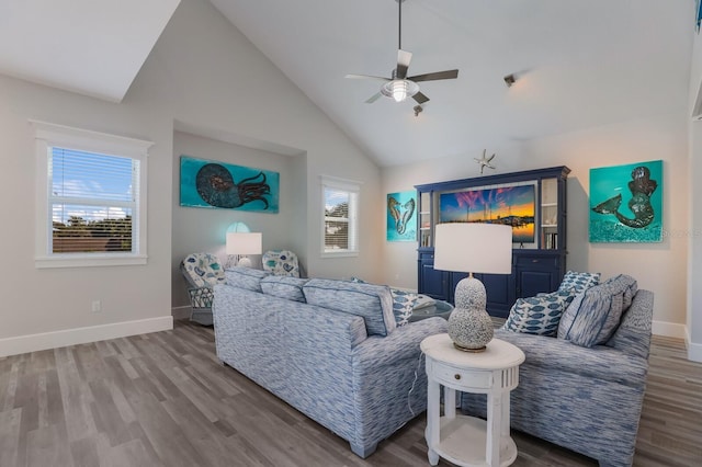 living room featuring wood-type flooring, high vaulted ceiling, and ceiling fan