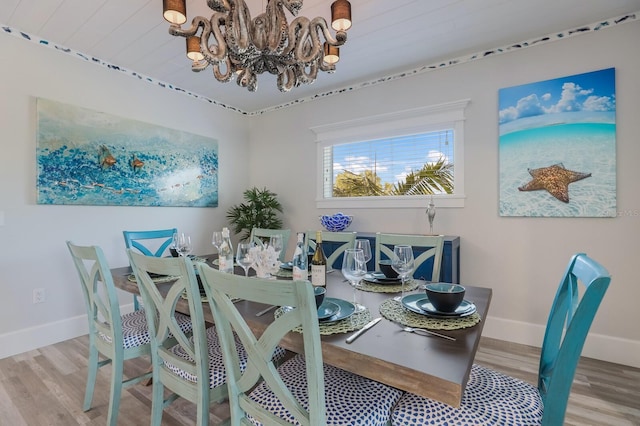 dining area featuring light hardwood / wood-style flooring and an inviting chandelier