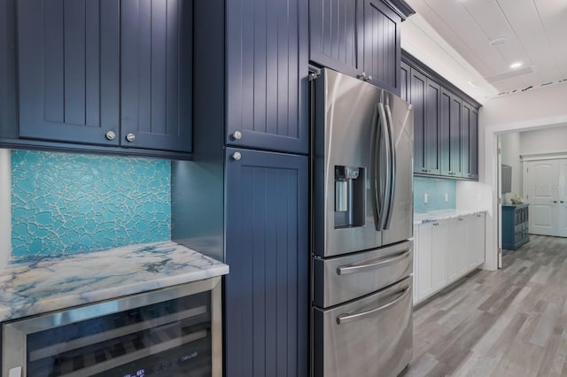 kitchen featuring backsplash, light hardwood / wood-style flooring, beverage cooler, and stainless steel refrigerator with ice dispenser