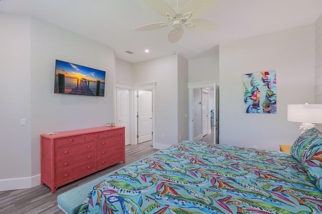 bedroom with ceiling fan and hardwood / wood-style flooring