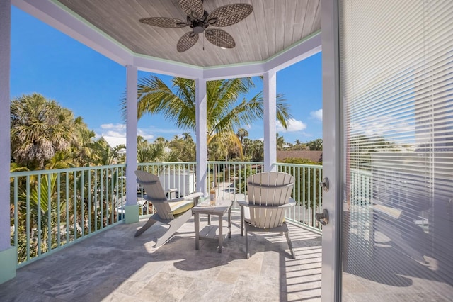 sunroom featuring ceiling fan and wooden ceiling