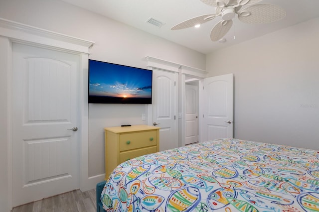 bedroom with light hardwood / wood-style floors and ceiling fan