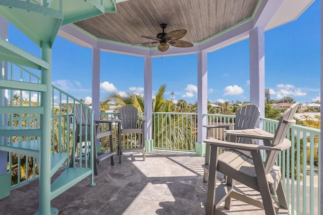 sunroom / solarium featuring ceiling fan and wooden ceiling