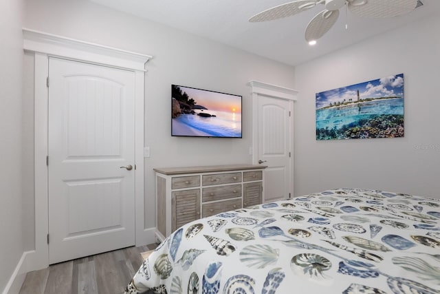 bedroom with light wood-type flooring and ceiling fan