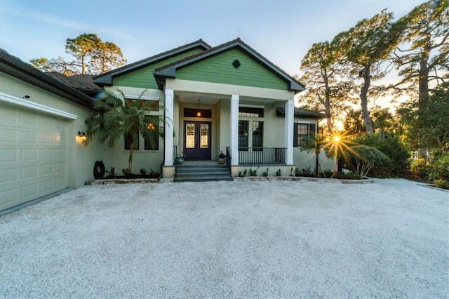 view of front facade with covered porch and a garage