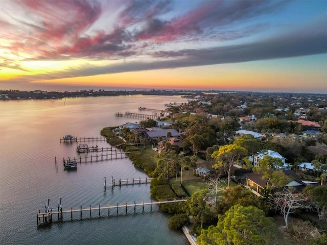 aerial view at dusk with a water view