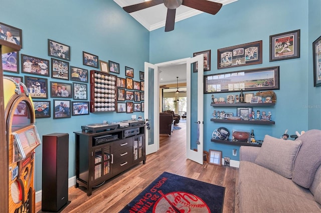 interior space with ceiling fan, hardwood / wood-style flooring, and ornamental molding