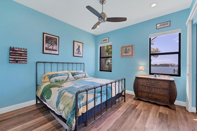 bedroom with ceiling fan and wood-type flooring