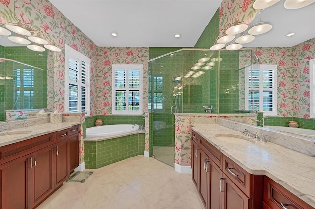 bathroom with vanity and independent shower and bath